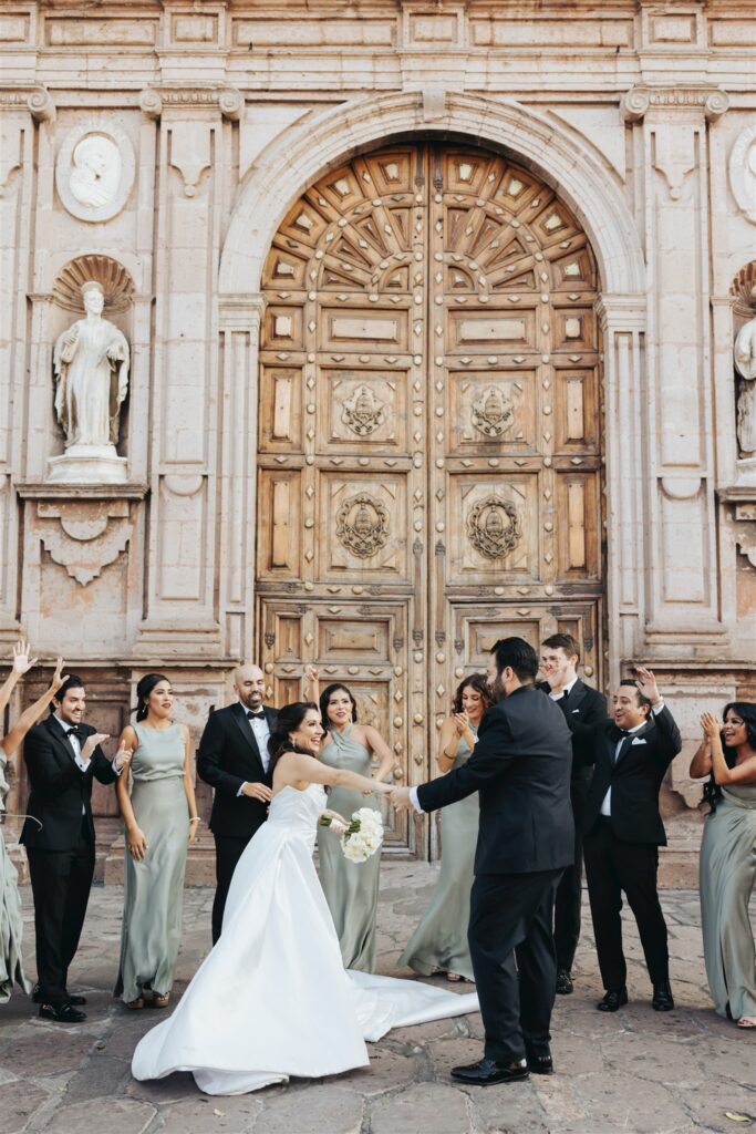 bride and groom family portraits in front of cathedral in morelia mexico
