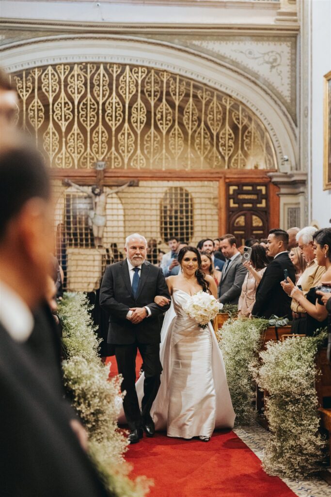 bride and father walking down the aisle wedding ceremony in catholic cathedral in morelia mexico