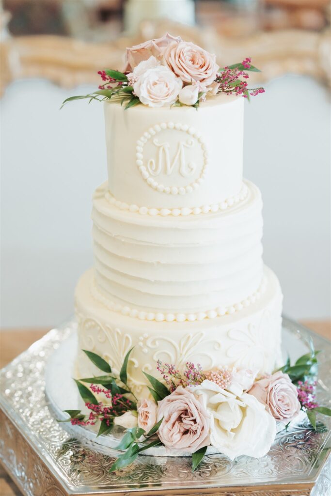 white cake with pink and white roses