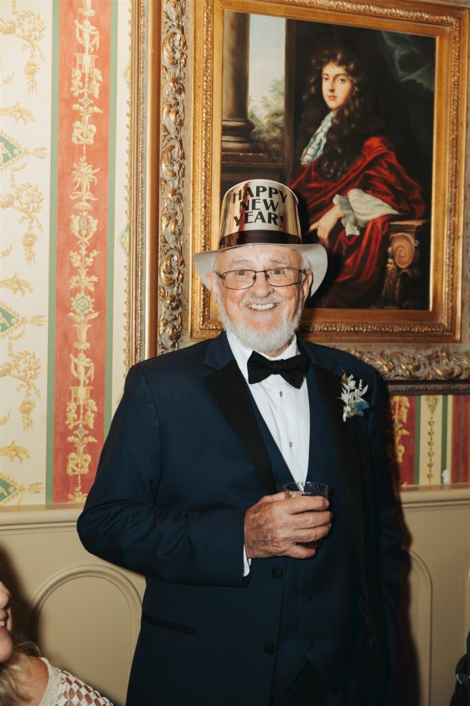 father of the bride in suit with new years eve hat