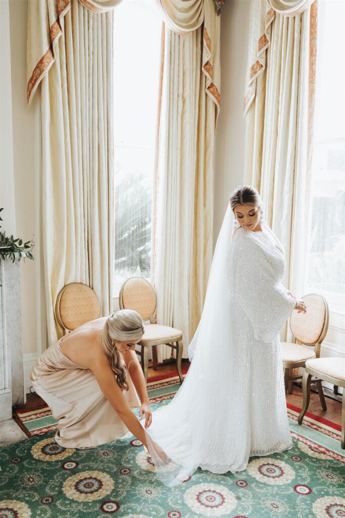 bride getting ready with bridesmaid at the Ezell House in Downtown Mobile Alabama