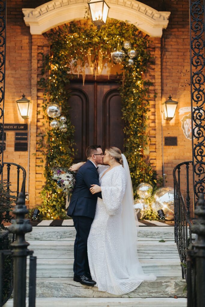 bride and groom kissing at the Ezell House in Downtown Mobile Alabama on New years eve wedding