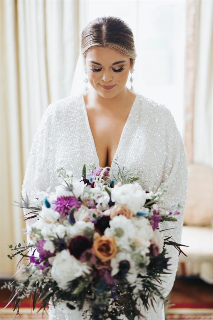 bride with sparkle wedding dress and purple flowers