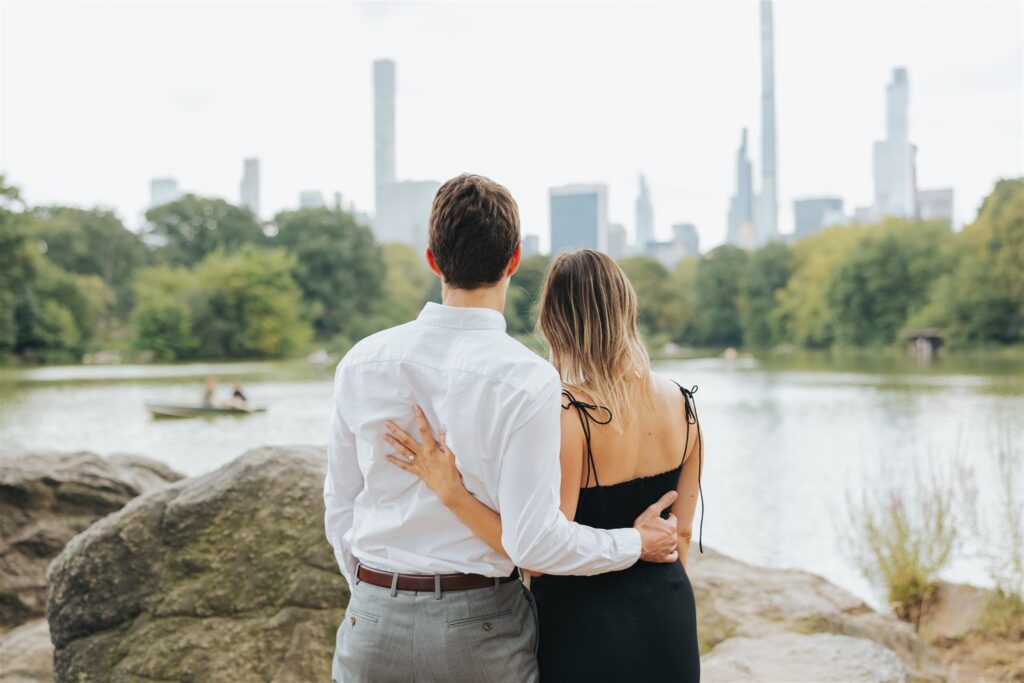 engaged couple hugging new york city
