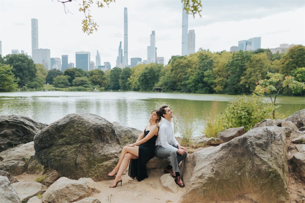 engaged couple sitting at park in new york city