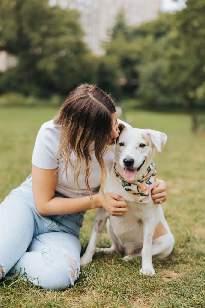 girl holding dog in central park