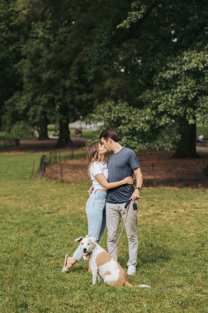 man and woman walking dog at central park
