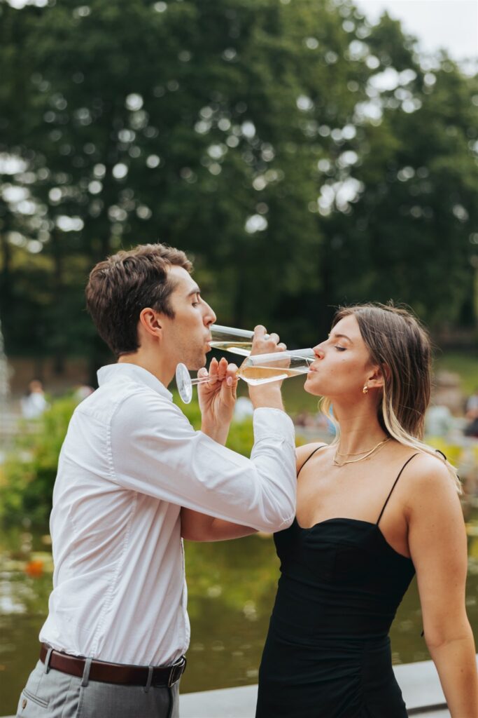 engaged couple drinking champagne at central park in new york city