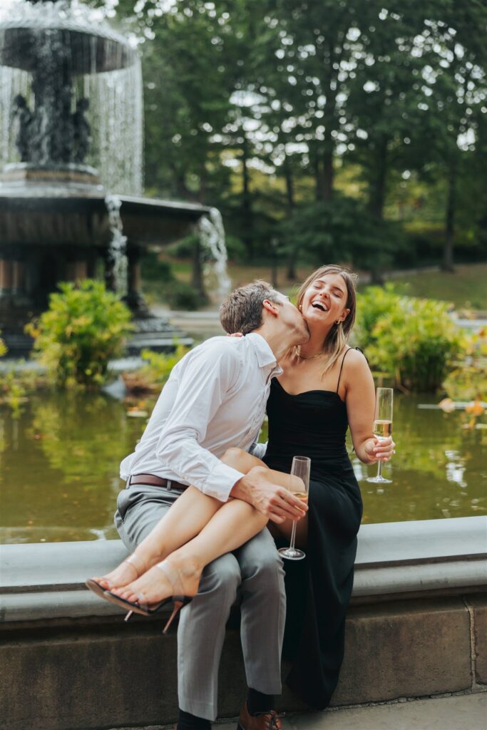engaged couple drinking champagne at central park in new york city