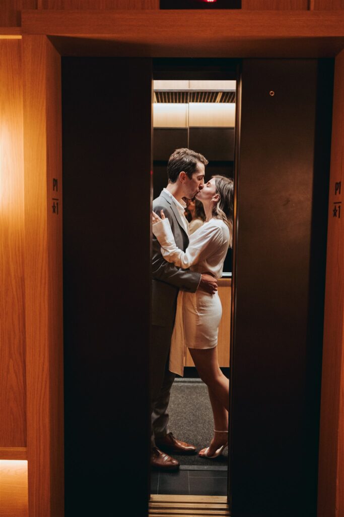 engaged couple kissing in elevator