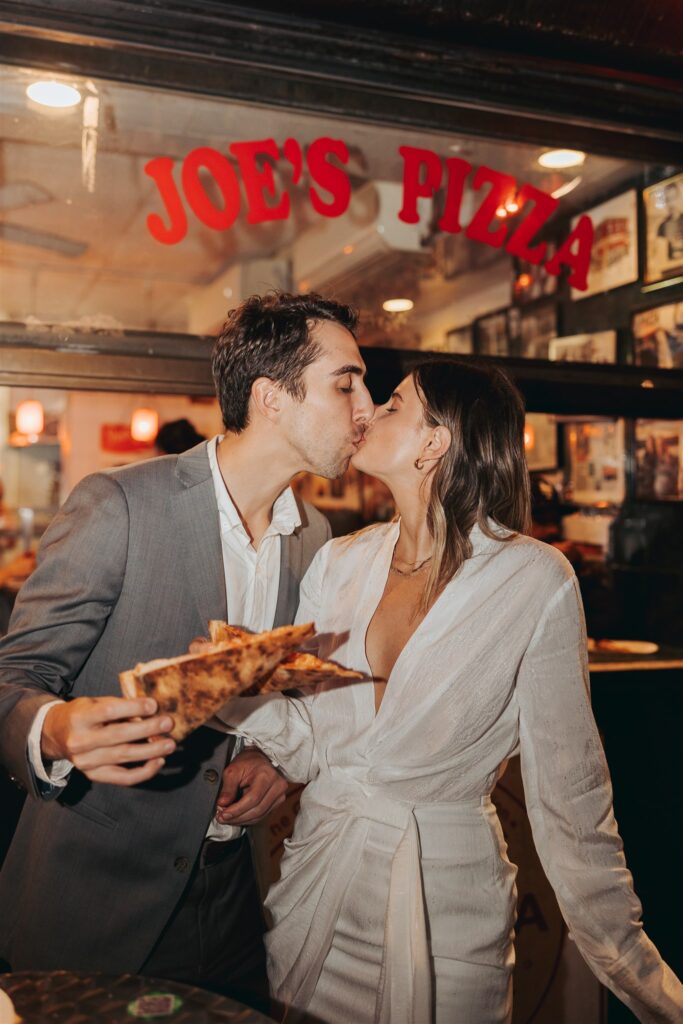 engaged couple kissing at pizza shop in new york city