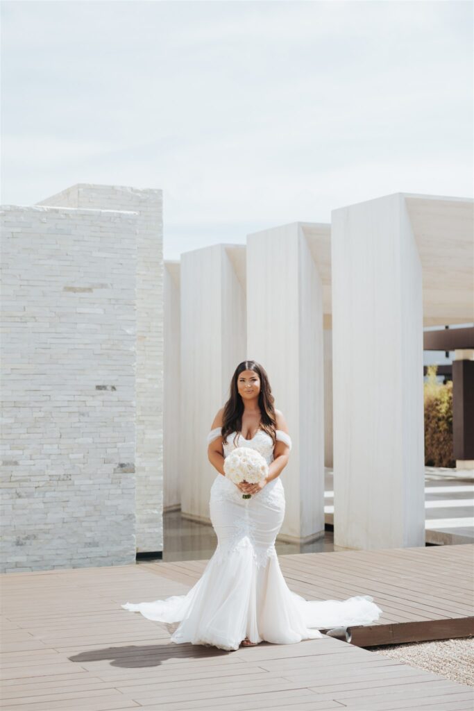 bride in wedding gown with white flowers