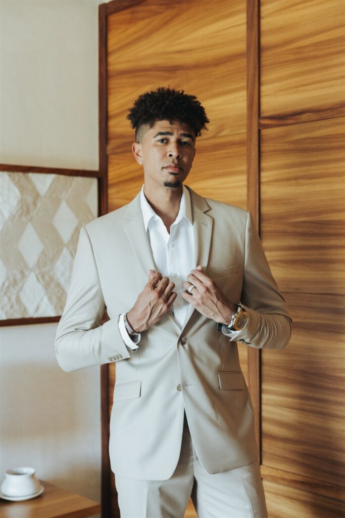 groom in tan and white suit