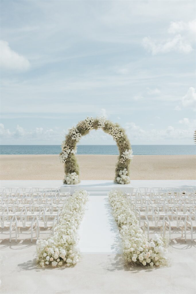 floral arch for wedding ceremony on the beach