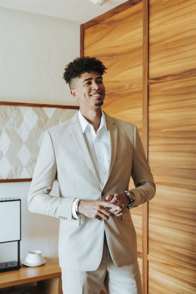 groom in tan and white suit