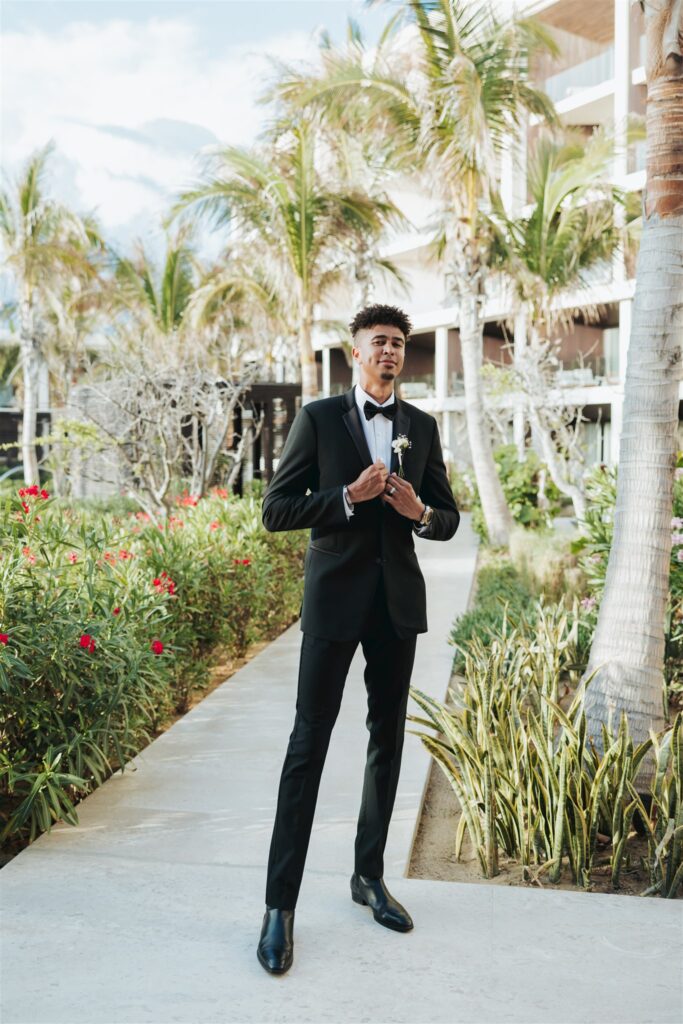 groom in front of hotel at the beach