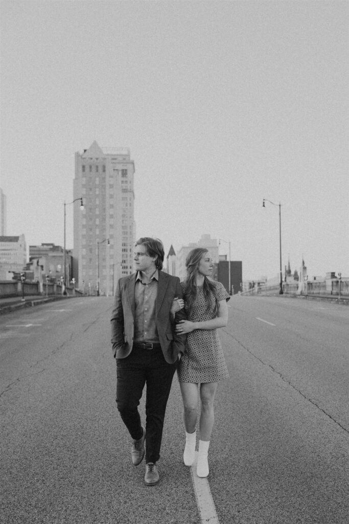couple standing in the street in the city at sunset