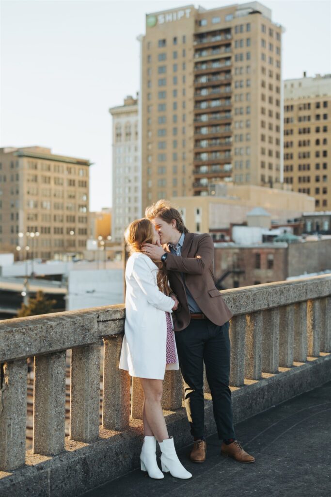 couple kissing in the street at sunset engagement session