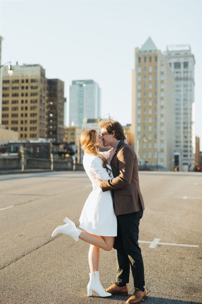 couple kissing in the street at sunset in Birmingham, Alabama engagement session