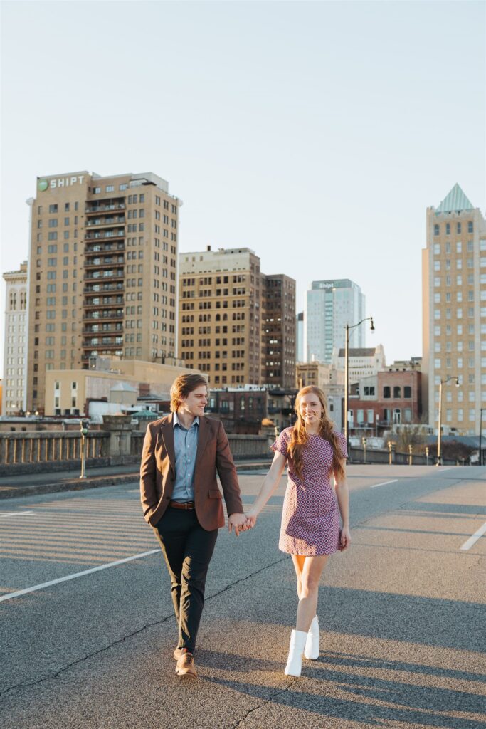 couple walking in the street at sunset engagement session