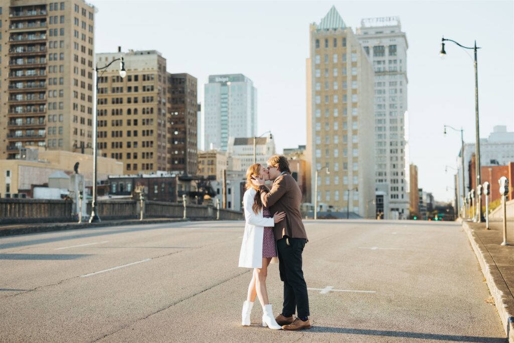 couple kissing in the street at sunset