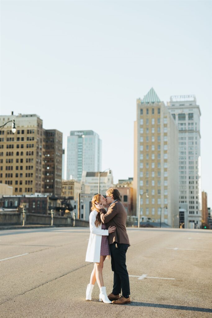 couple kissing in the street at sunset in Birmingham Alabama