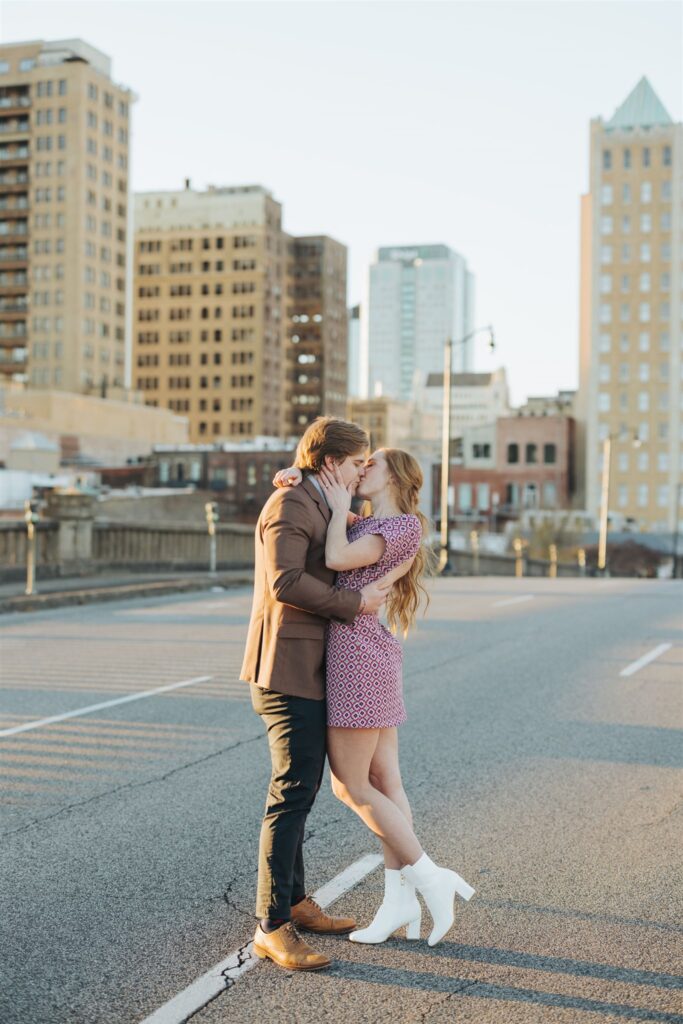 couple hugging in the street at sunset engagement session