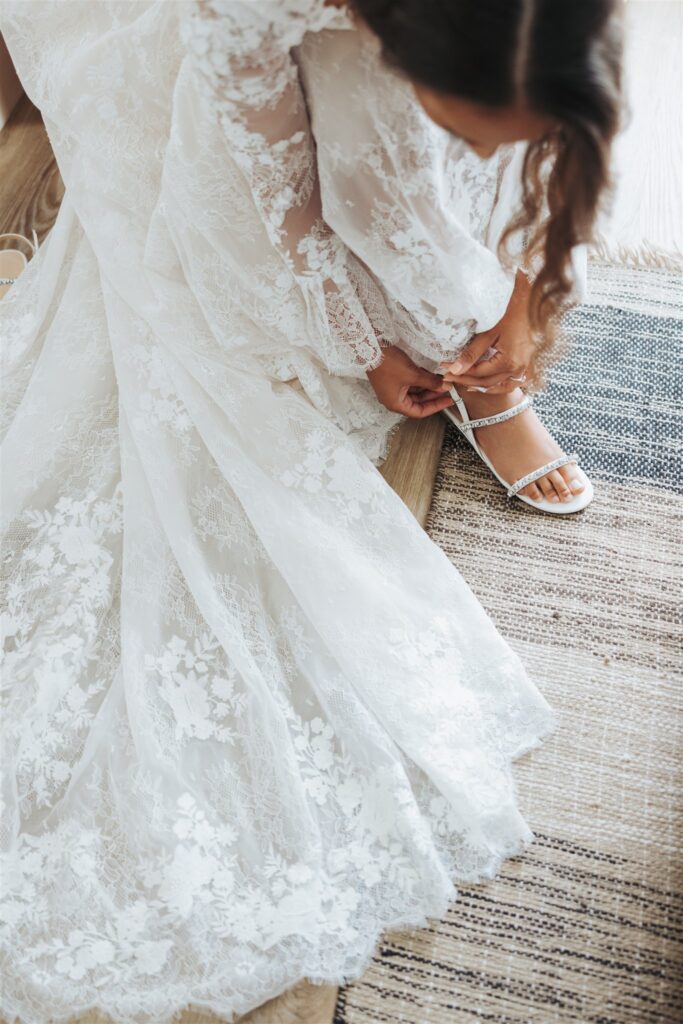 bride getting ready and putting on wedding shoes