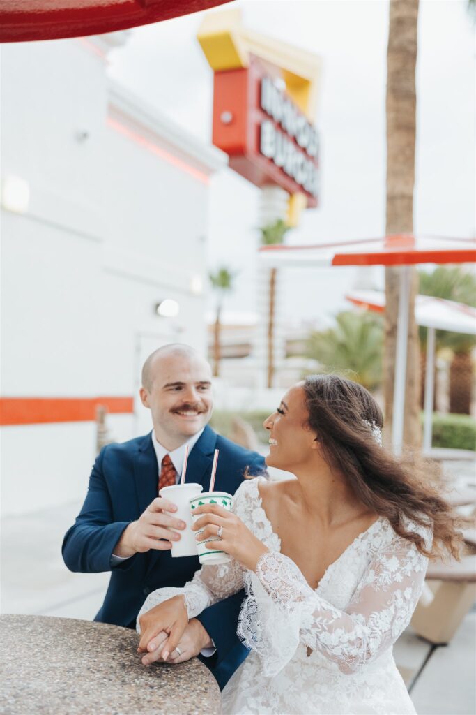 bride and groom drinking sodas at fast food