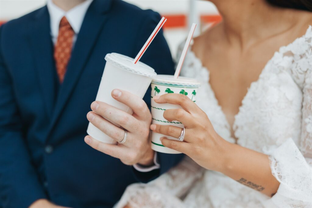 bride and groom drinking sodas at fast food