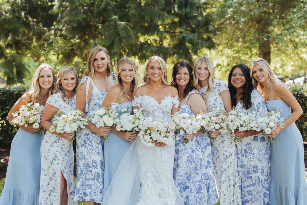 bride portrait with bridesmaids in floral dresses