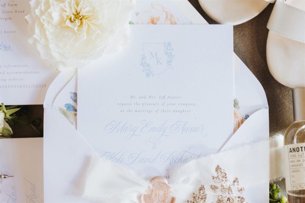 white and pink and blue wedding stationary
