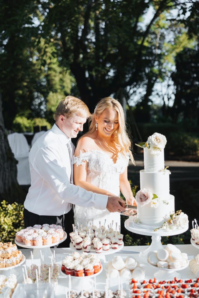 bride and groom garden party wedding cake cutting