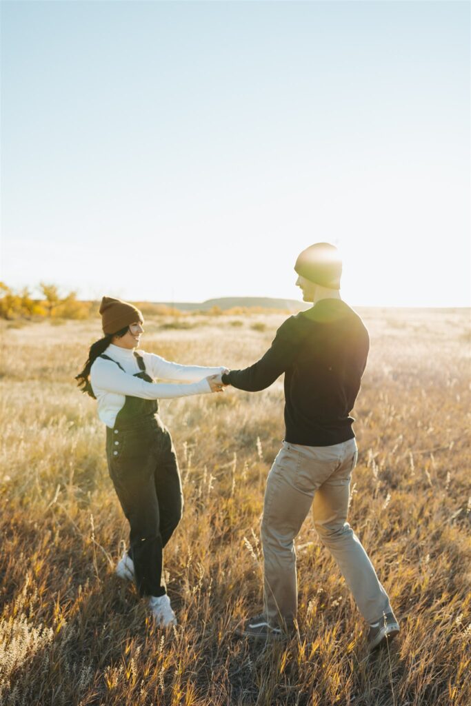 couple hugging in a field in the fall in colorado