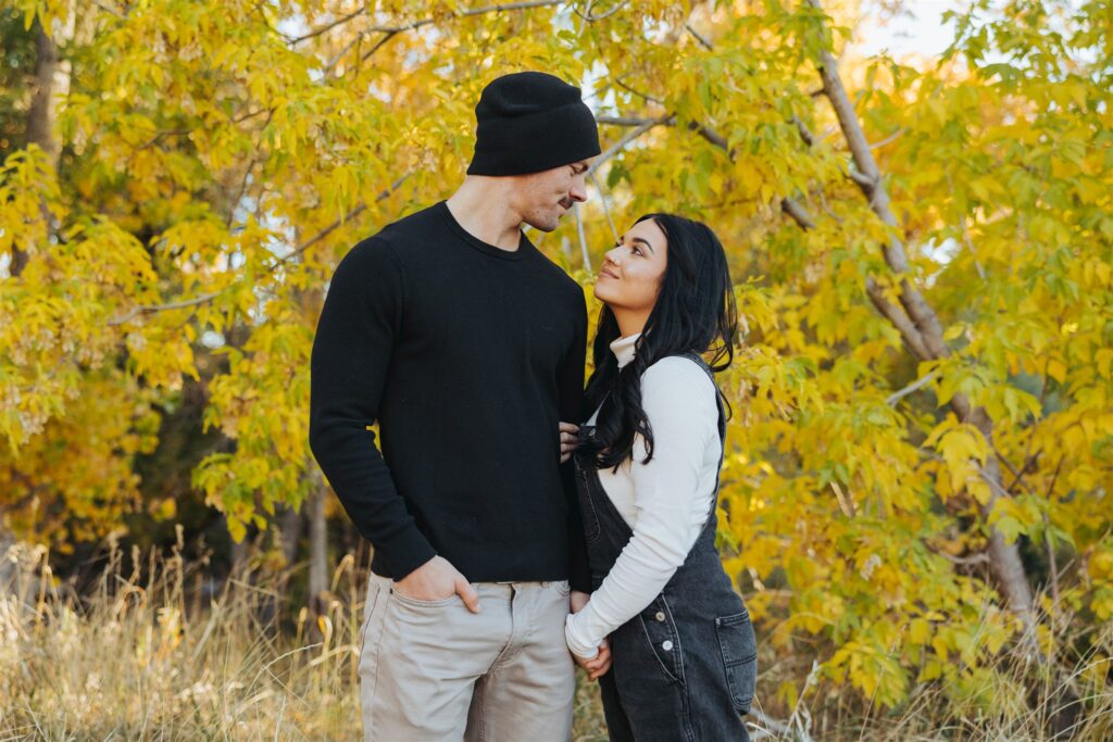 couple walking in the woods in the fall