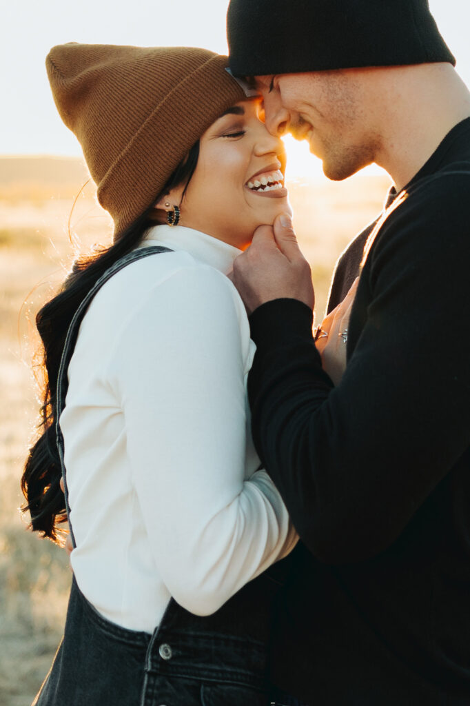 couple hugging in a field in the fall engagement session