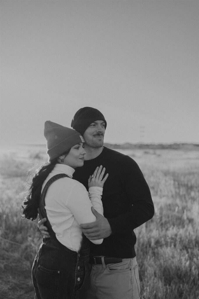 couple hugging in a field in the fall